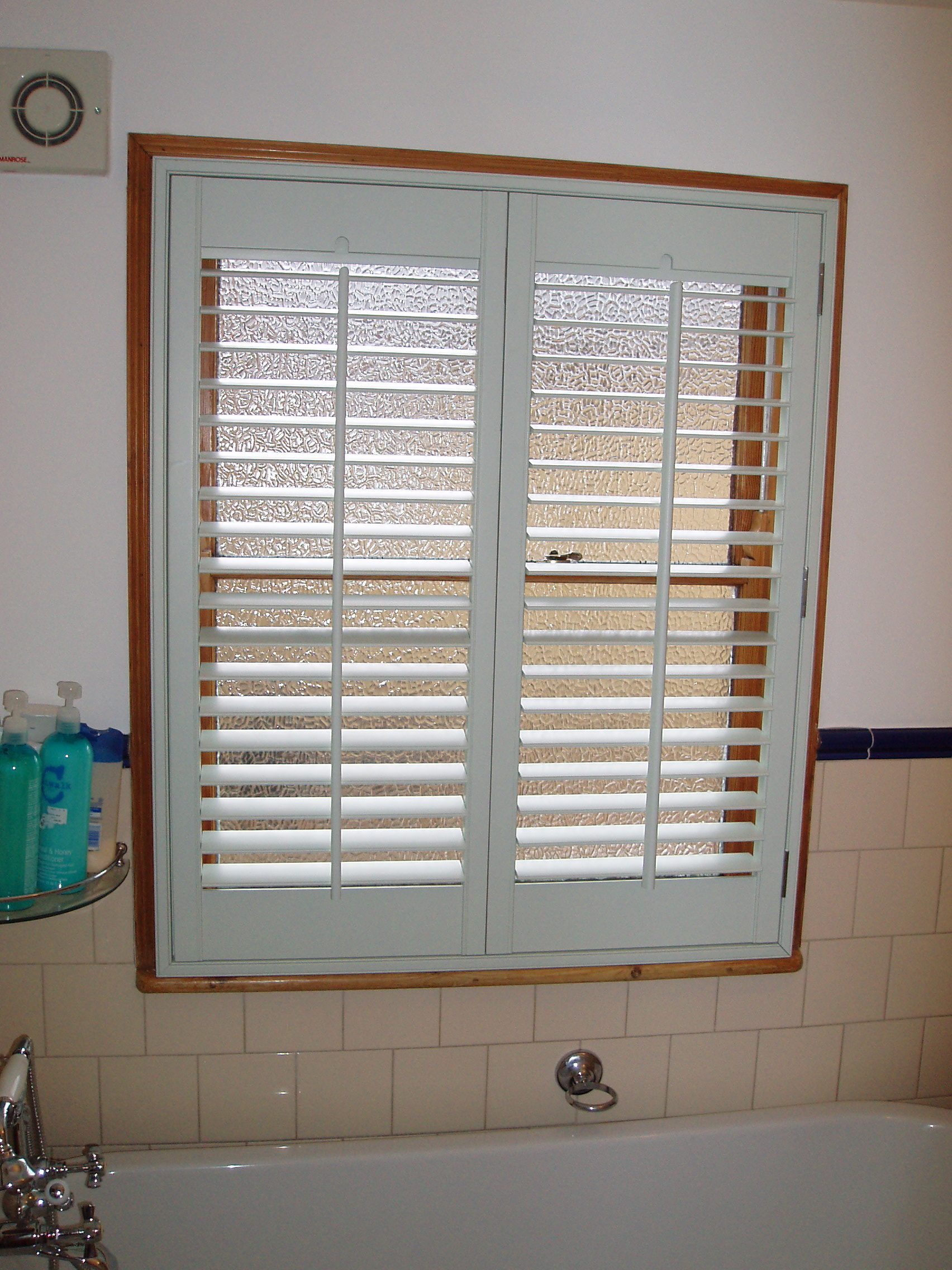 Custom colour shutters fitted in bathroom in Hertford  - Plantation shutters -  Carolina Blinds