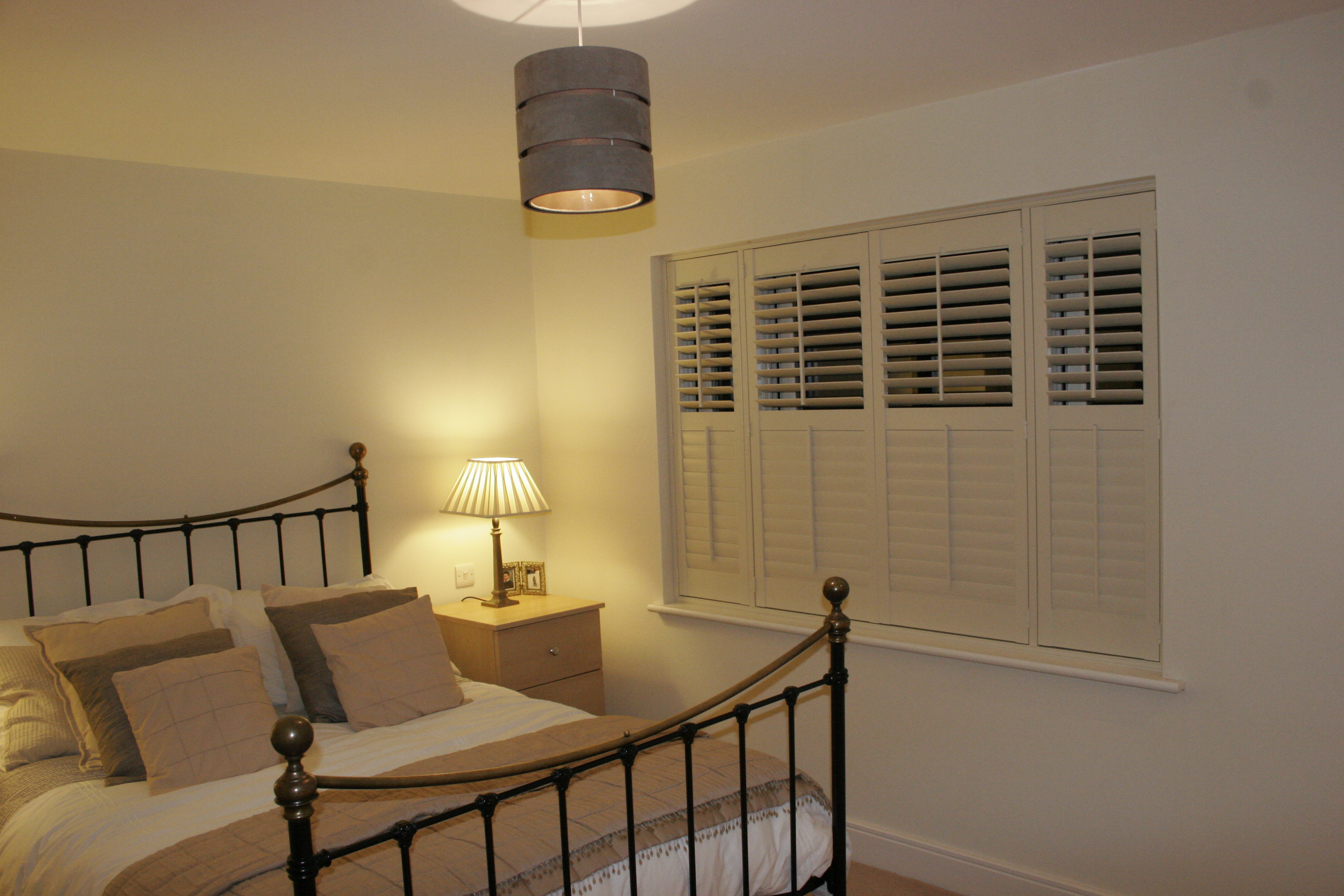 Cream shutters fitted in bedroom in Hoddeson  - Plantation shutters -  Carolina Blinds