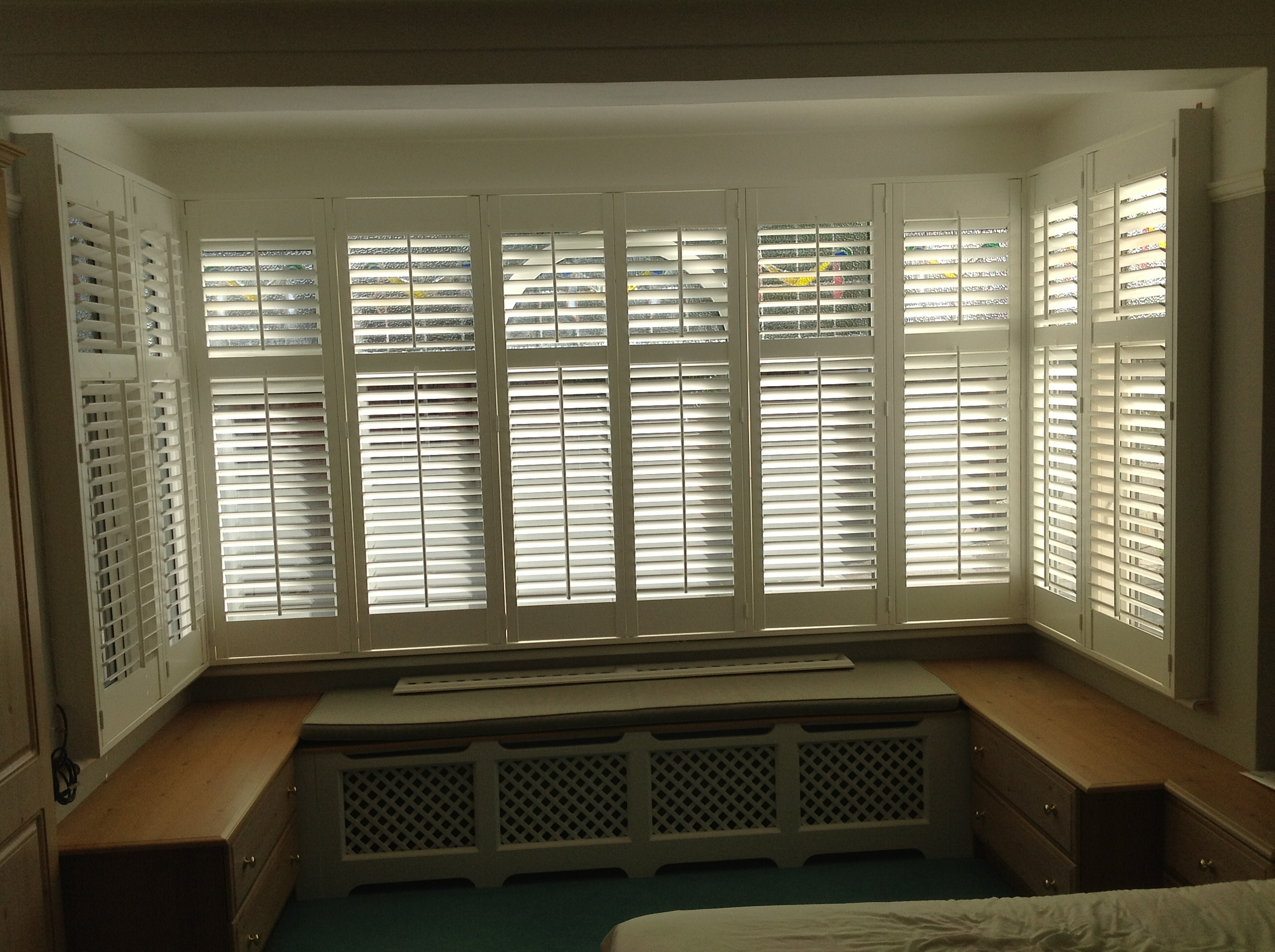 Shutters fitted around large bedroom bay window Winchmore Hill  - Plantation shutters -  Carolina Blinds