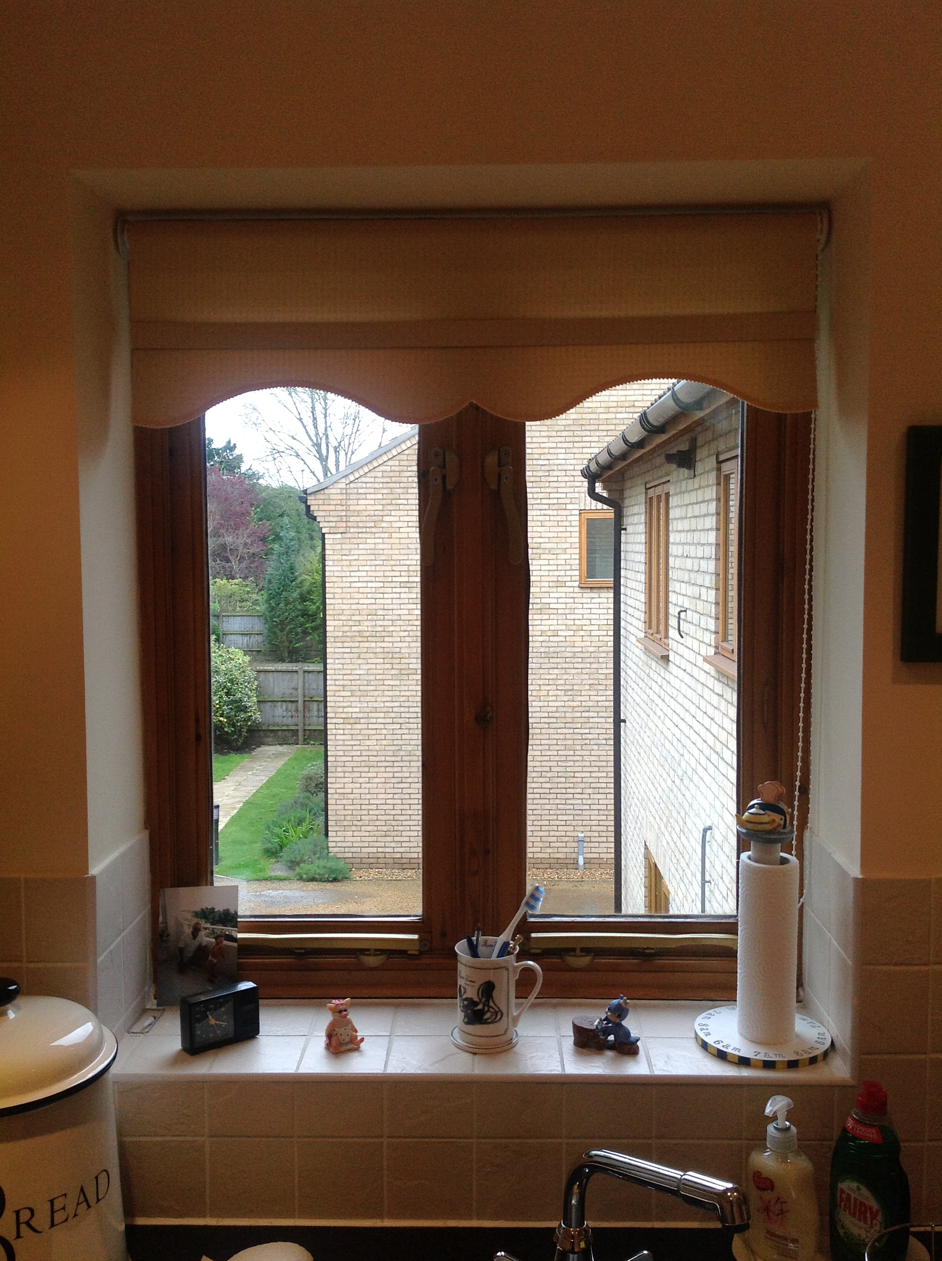 Roller blind fitted in kitchen with colonial shaped bottom and braid  - Roller blinds -  Carolina Blinds